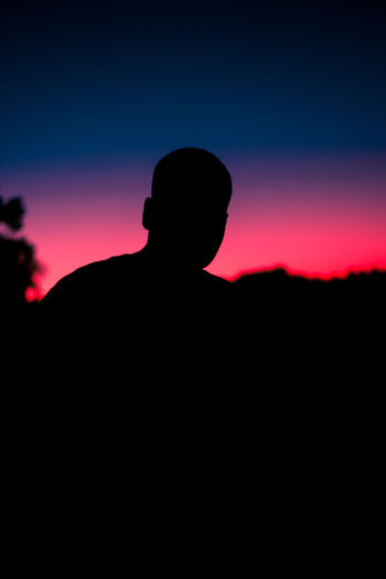 Silhouette man against clear sky during sunset