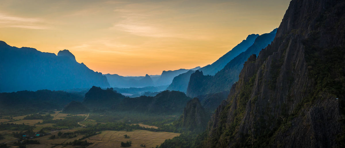 Scenic view of mountains against sky during sunset