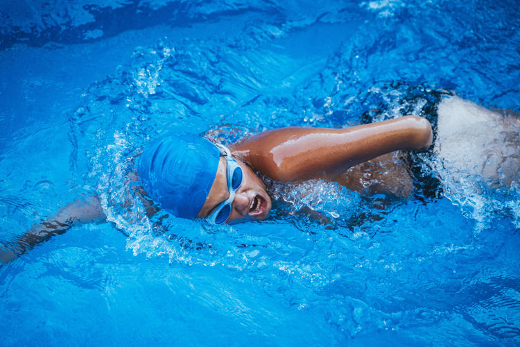 Low section of woman swimming in pool