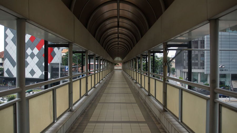Empty walkway leading towards building
