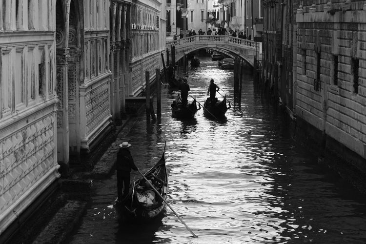 Bridge of sighs over canal with gondolier