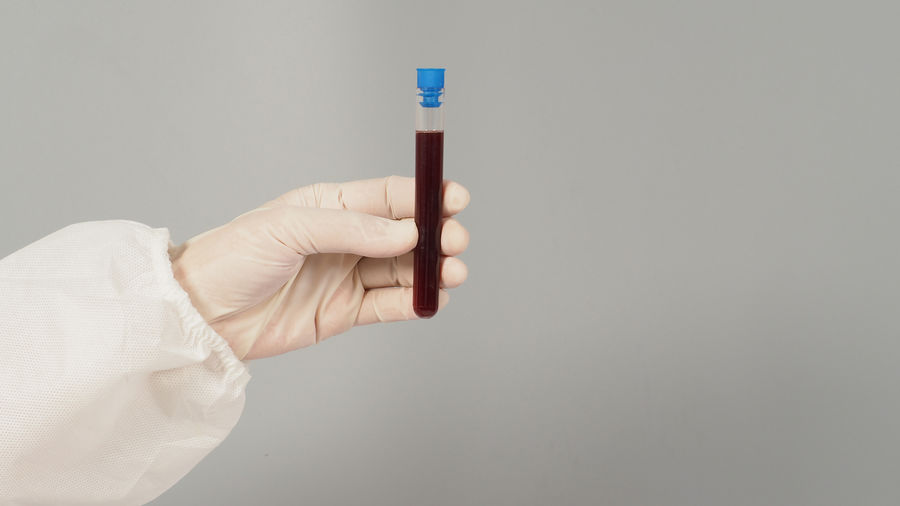Close-up of hand holding thermometer