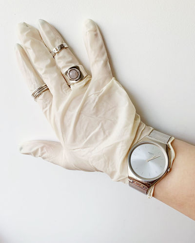 High angle view of person holding clock against white background