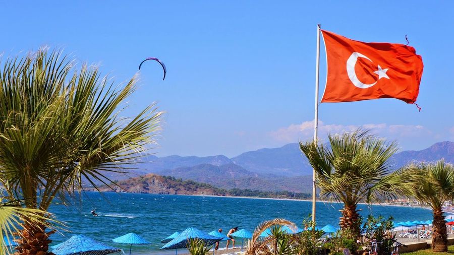 Turkish flag at tourist resort with mountain s in background