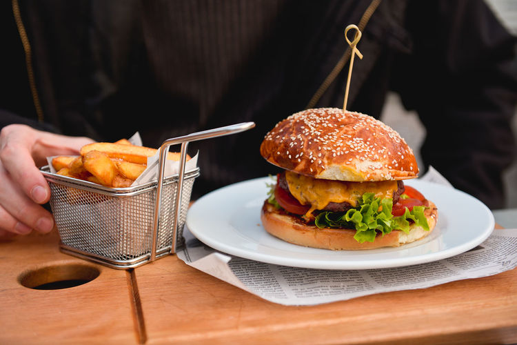 Close-up of burger and french fries served on plate