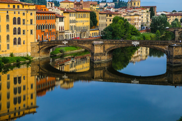 Reflection of the bridge in the river arno in florence