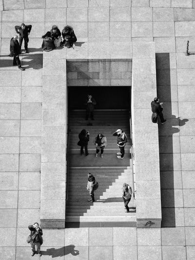 People seen from above near stairs entering an underground passage in berlin, germany