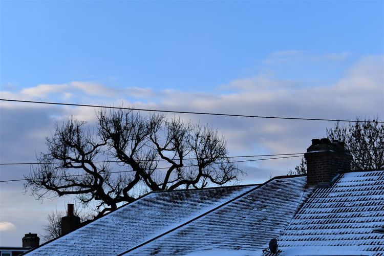 Low angle view of building against sky during winter