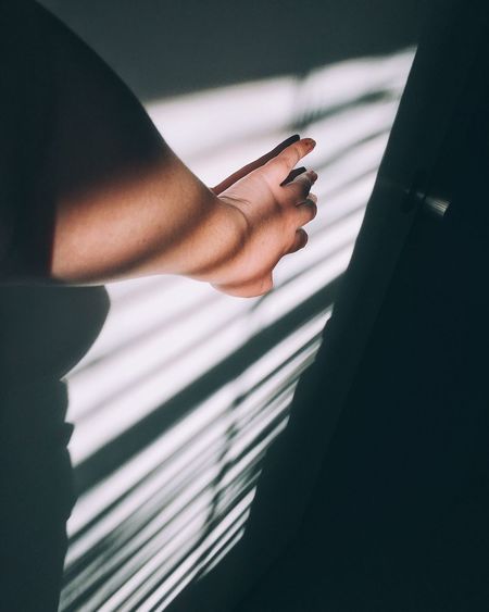 Sunlight falling on hand of person