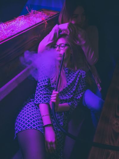 High angle view of women smoking hookah at nightclub