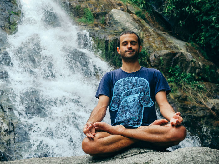 Portrait of man in waterfall