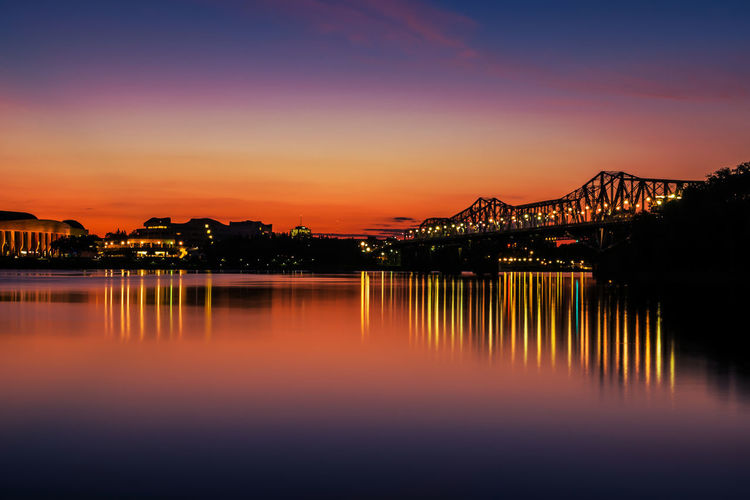 Illuminated silhouette alexandra bridge over ottawa river 
