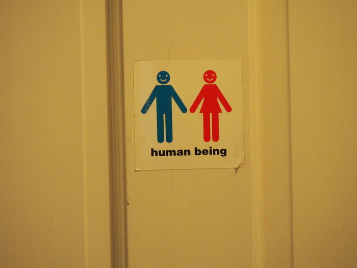 Close-up of restroom sign on door
