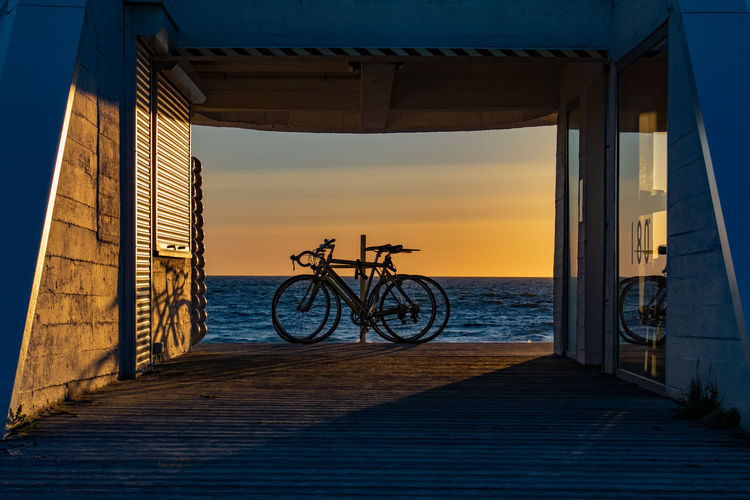 Bicycle silhouettes during sunset at the beach near nida, lithuania