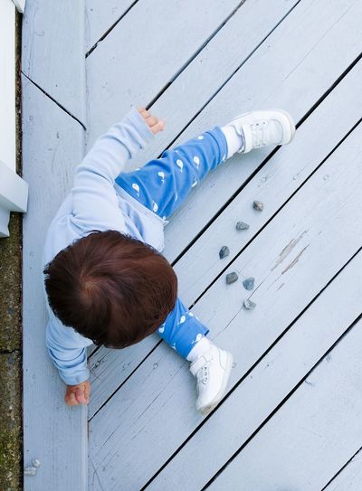 High angle view of boy with blue umbrella
