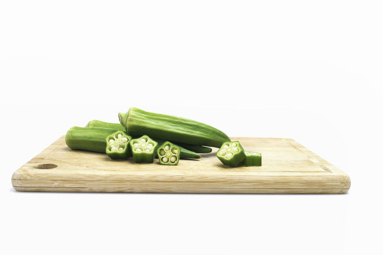 High angle view of chopped vegetables on cutting board against white background