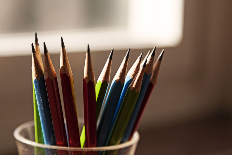 Several pencils in backlight by window