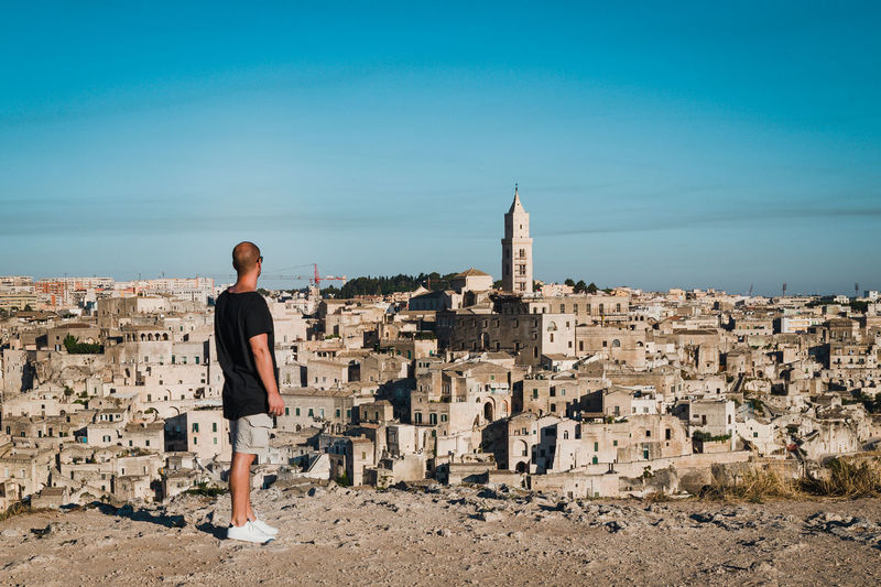 Rear view of man looking at ancient city of matera