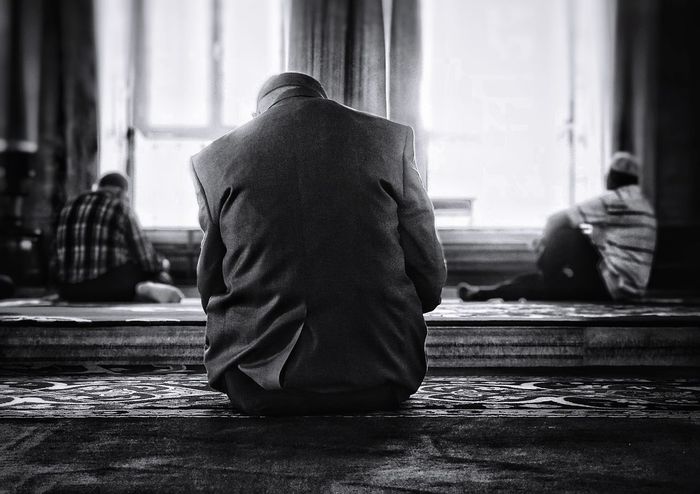 Men sitting in mosque