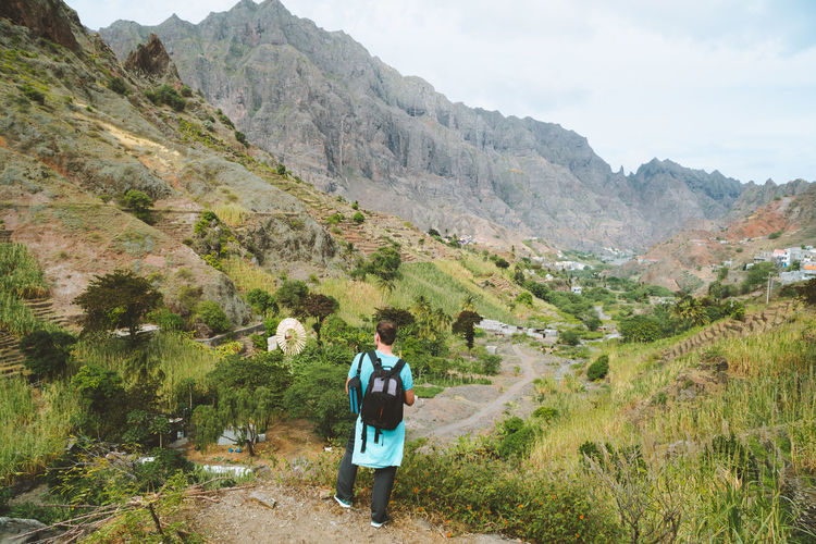Rear view of man standing on mountain