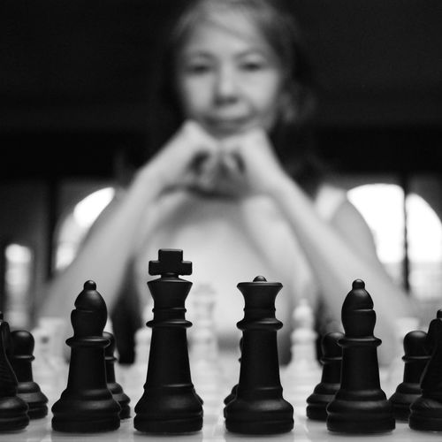 Low angle view of girl playing on chess