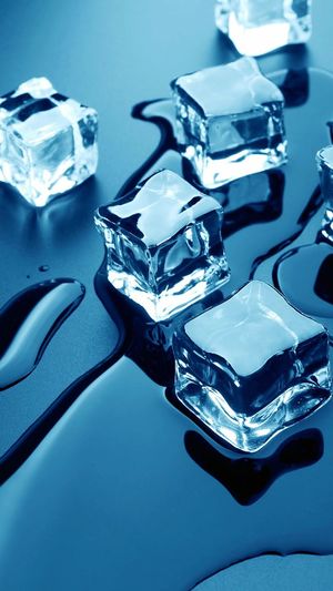 High angle view of melting ice cubes on table