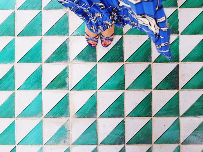 Low section of people standing on tiled floor