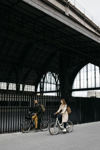 Couple riding e-bikes in the city