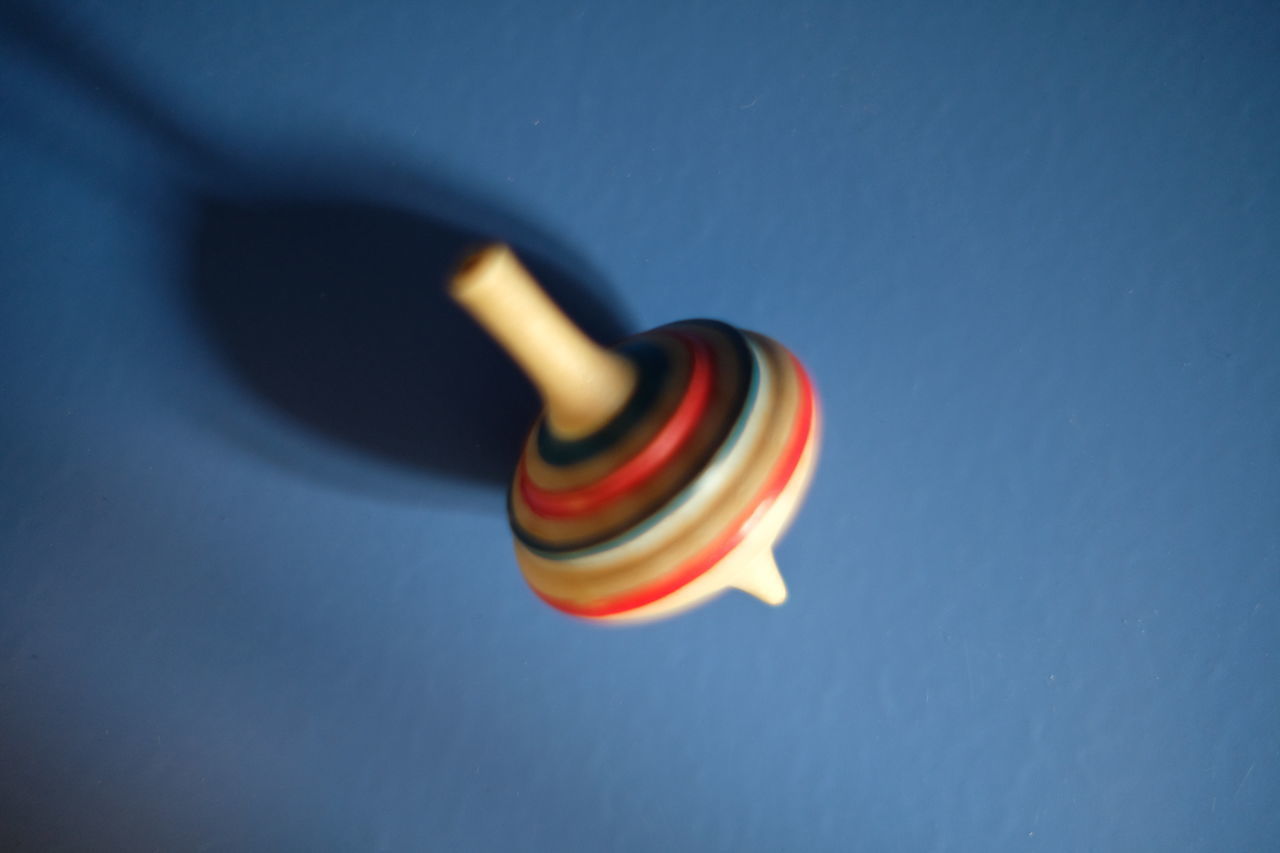 HIGH ANGLE VIEW OF TOY AGAINST BLUE WALL