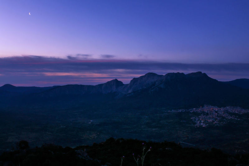 Scenic view of silhouette mountains against sky at sunset