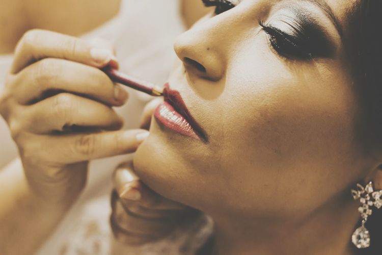 Close-up of woman applying lipstick