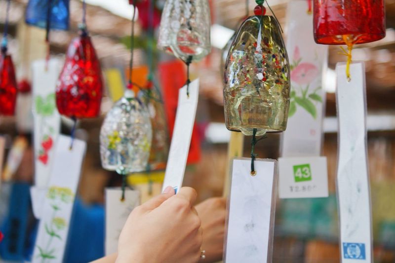Close-up of hand holding wind chime at market