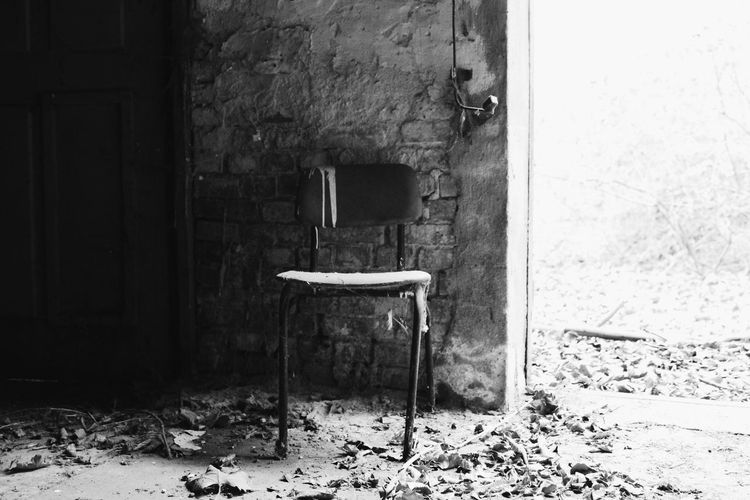 Empty chair in abandoned building