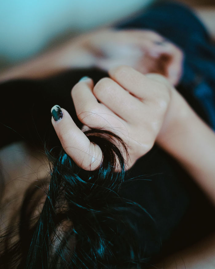 Close-up of woman hand holding hair