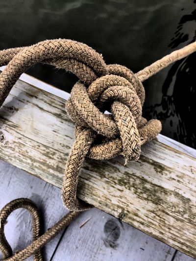 Close-up of rope on wooden wall