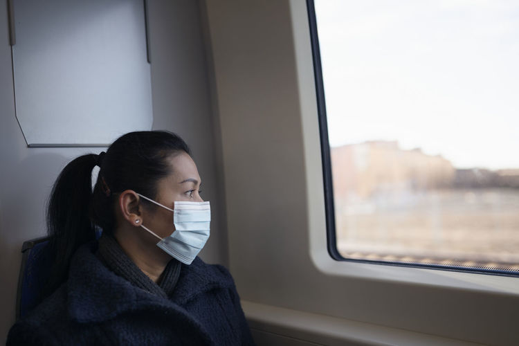 Woman wearing face mask in train