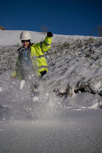 Rear view of man skiing on snow