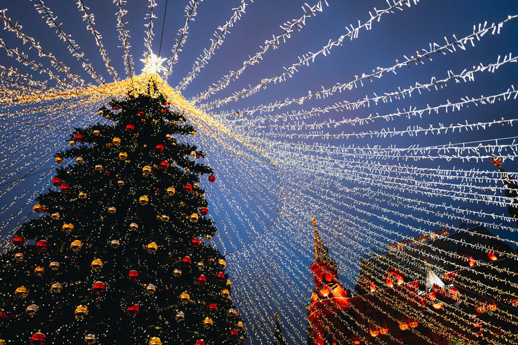 Festive golden garlands and shiny decorations with christmas tree as symbol of happy new year