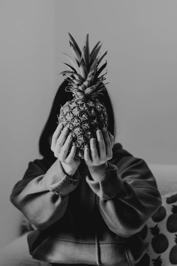 Midsection of woman holding pineapple 