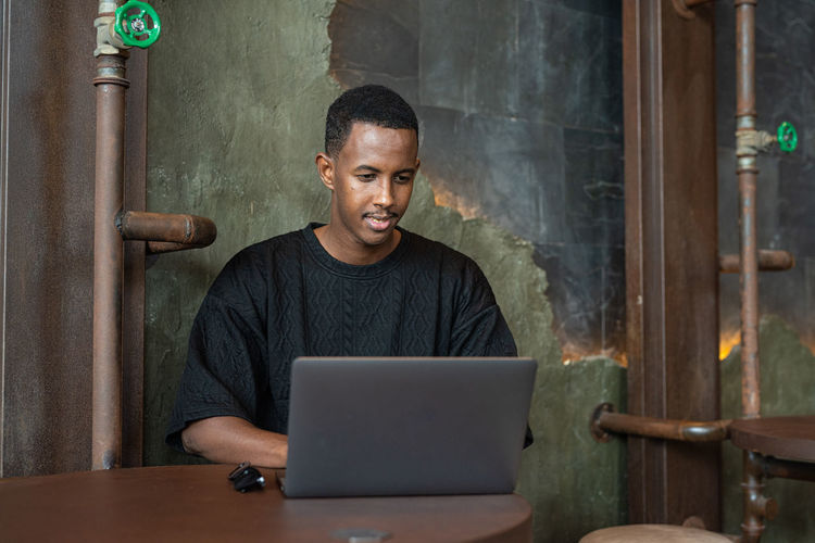 Young man using laptop while sitting at home