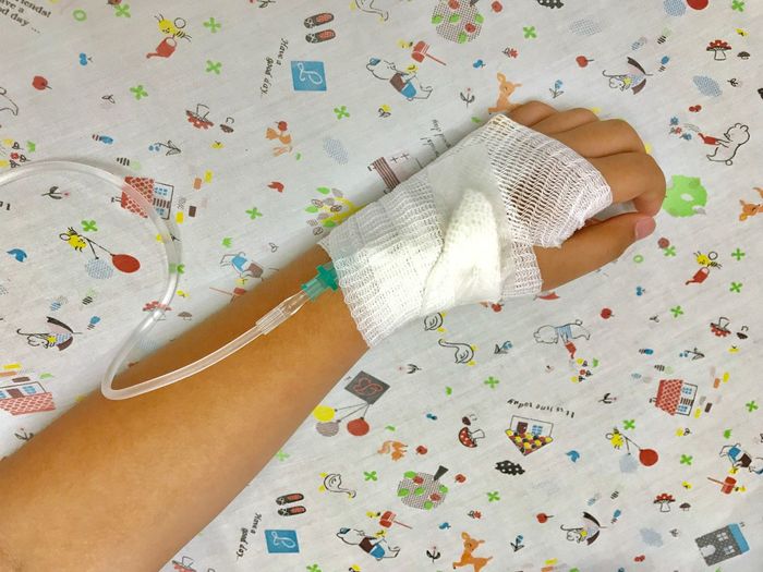 Cropped hand with iv drip on hand