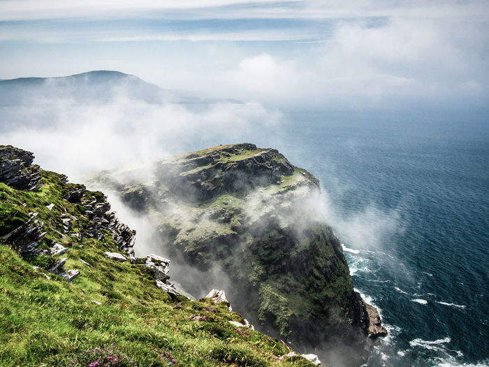 High angle view of sea and mountains against sky