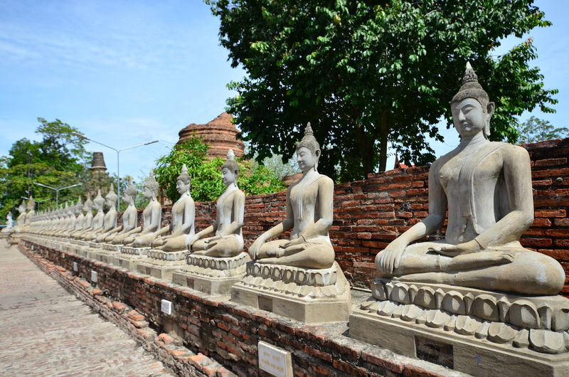 Statue against temple and building