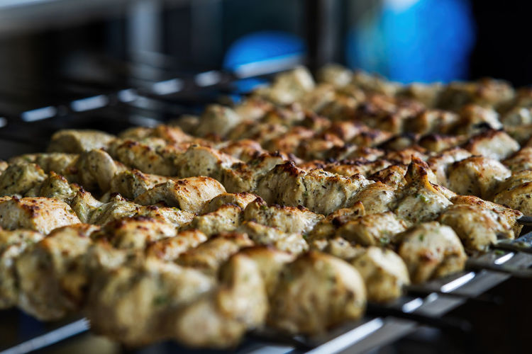 Cooking chicken tikka, traditional indian and pakistani dish cooked on charcoal and flame.