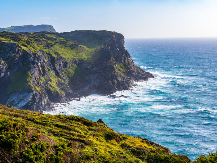 Cliff above lampianu beach at sunset, near stintino, sardinia, italy