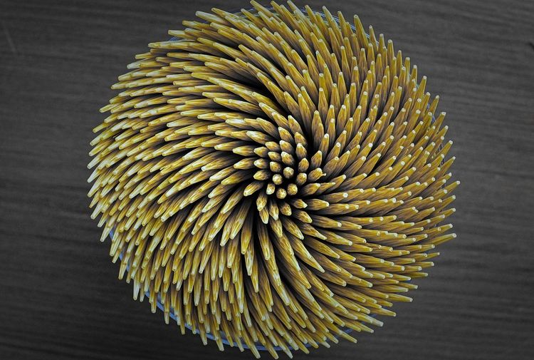 High angle view of toothpicks on wooden table