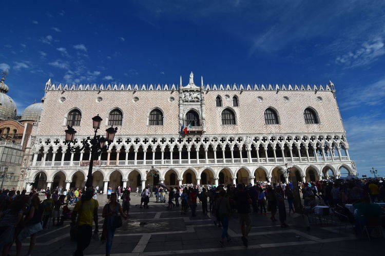 People at doges palace against sky