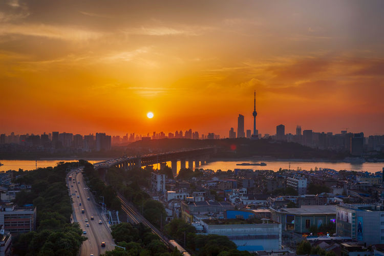 High angle view of buildings in city during sunset