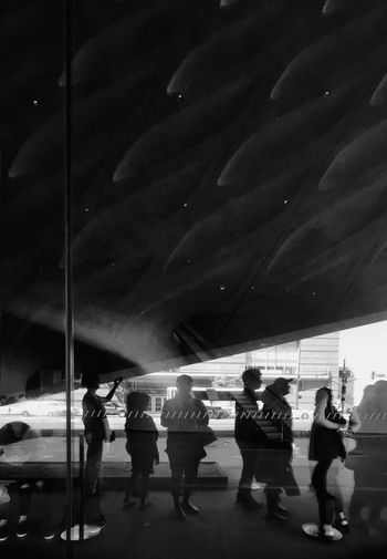 People walking on footpath against sky