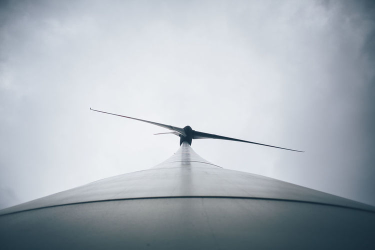 Low angle view of windmill against sky
